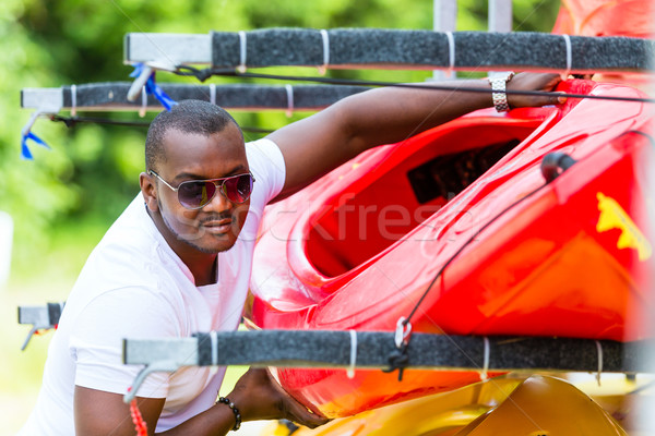 Stock photo: African man unloading boat from trailer