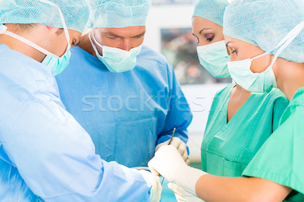 Surgeons operating patient in operation theater Stock photo © Kzenon
