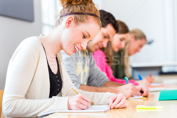 College students writing test or exam Stock photo © Kzenon