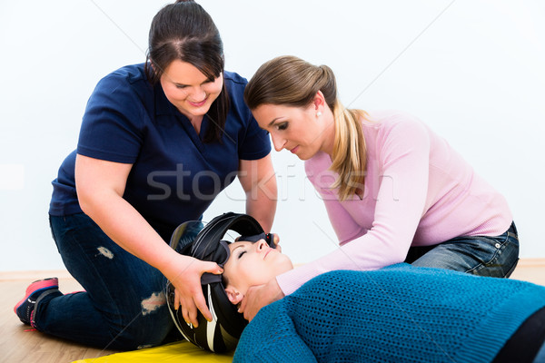 First aiders practicing to remove the helmet of injured biker Stock photo © Kzenon