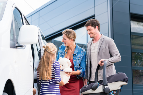 Stock photo: Family checking new car in car dealership