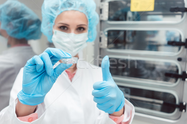 Lab technician or scientist with dish in front of incubator Stock photo © Kzenon
