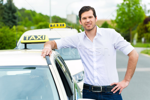 Driver in front of taxi waiting for clients Stock photo © Kzenon