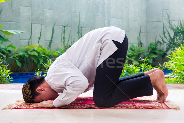 Asian Muslim man praying on carpet  Stock photo © Kzenon
