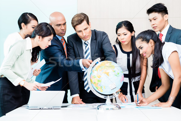 Business team discussing global market intelligence Stock photo © Kzenon