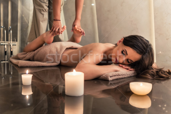 Young woman enjoying the stretching techniques of Thai massage Stock photo © Kzenon