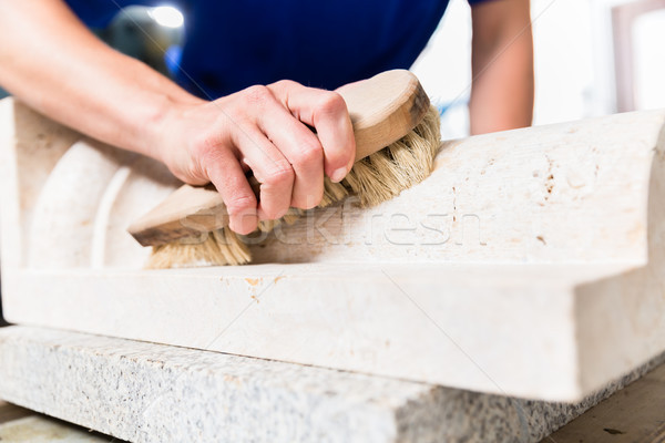 Stonemason brushing stone dust off workpiece Stock photo © Kzenon