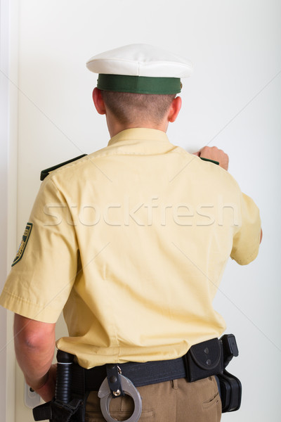 Rendőrtiszt bejárati ajtó otthon férfi rendőrség irányítás Stock fotó © Kzenon