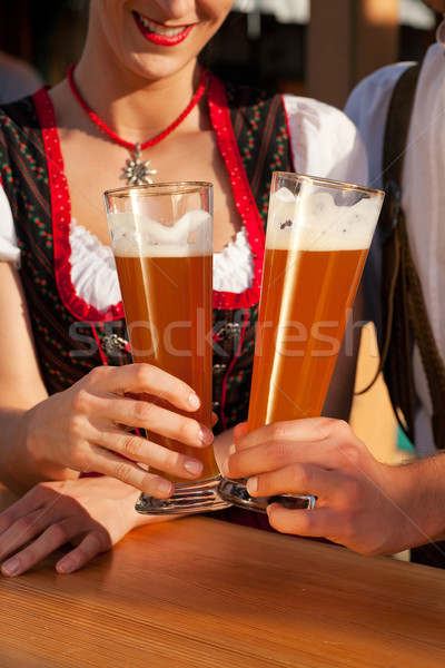 Couple in Bavarian Tracht clinking glasses  Stock photo © Kzenon