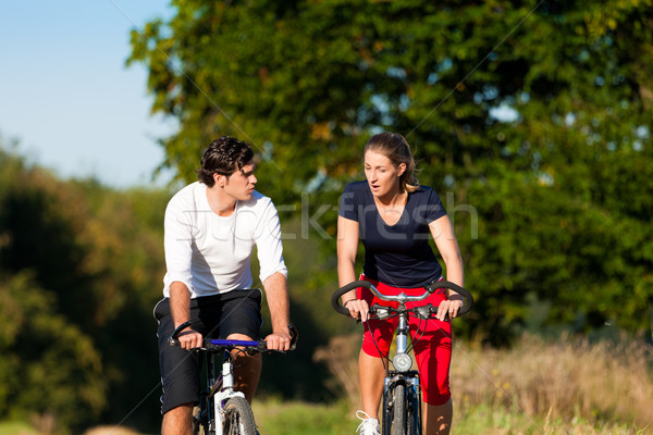 Man and woman exercising with bicycle Stock photo © Kzenon