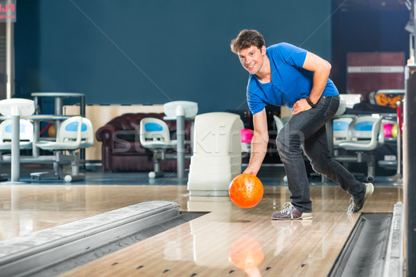 Young man bowling having fun Stock photo © Kzenon