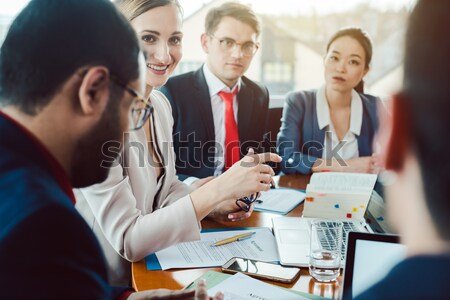 Mixed business team discussing earnings Stock photo © Kzenon