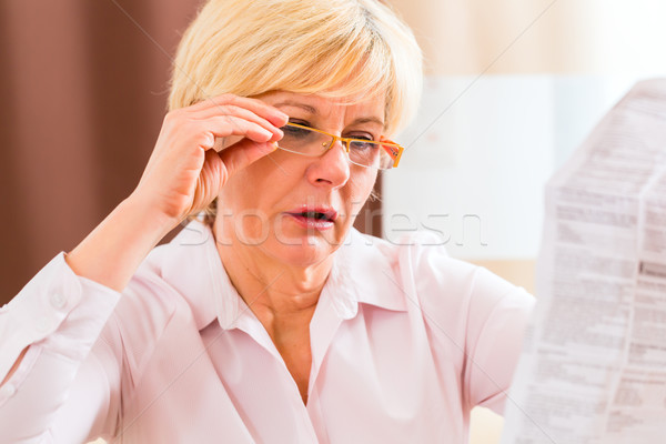 Senior reading with presbyopia package insert Stock photo © Kzenon