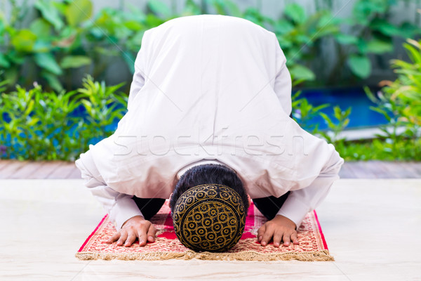 Asian Muslim man praying on carpet Stock photo © Kzenon