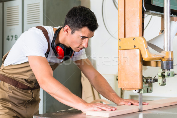 Carpenter cutting board with jig saw on his workbench Stock photo © Kzenon