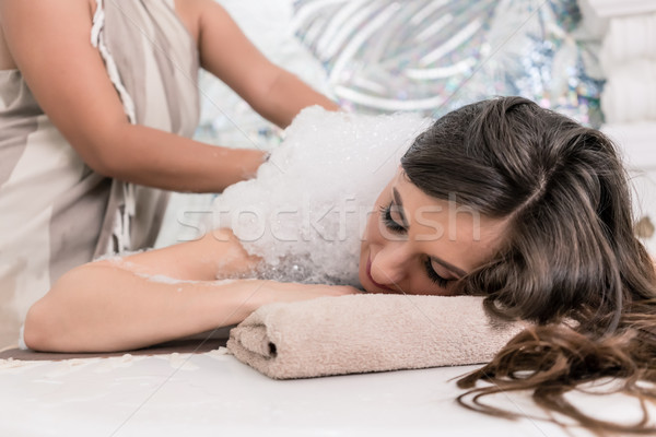 Young woman relaxing on hot marble bed during traditional Turkis Stock photo © Kzenon