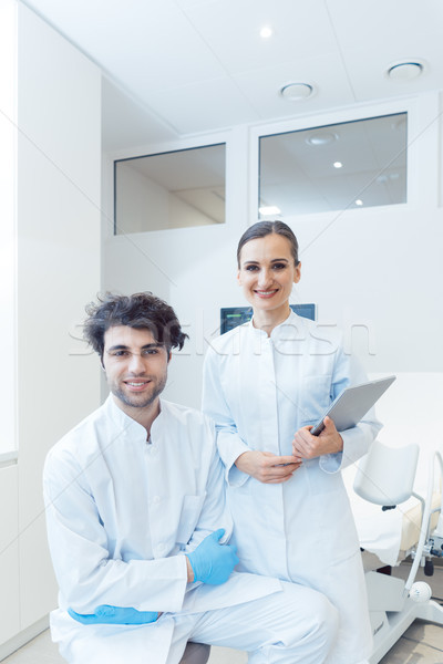 Doctor woman and man with tablet computer in their practice Stock photo © Kzenon