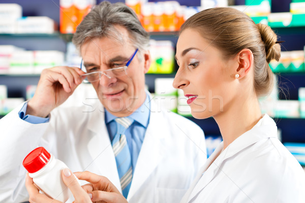 Stock photo: Two pharmacists in pharmacy consulting