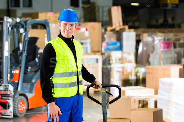 Storeman with mover at warehouse of forwarding Stock photo © Kzenon