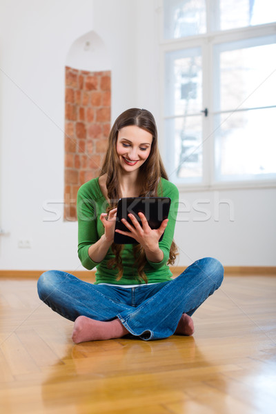 Stock photo: Young woman doing online dating