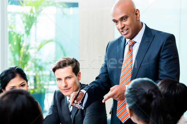 Indian Business man leading team meeting Stock photo © Kzenon