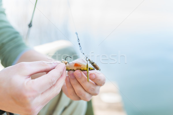 Angler fixing lure at hoof of fishing rod Stock photo © Kzenon