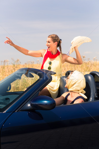 friends having summer joyride in convertible car  Stock photo © Kzenon