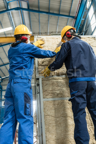 Workers applying insulation material to an industrial boiler Stock photo © Kzenon