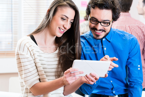 Young business people looking at tablet PC Stock photo © Kzenon