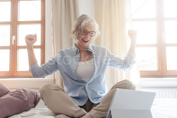 Senior business woman being excited about a success  Stock photo © Kzenon