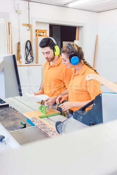 Carpenter programming computer controlled saw Stock photo © Kzenon