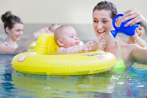 Mothers and kids having fun together playing with toys in pool Stock photo © Kzenon