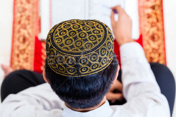Asian Muslim man studying Koran or Quran Stock photo © Kzenon
