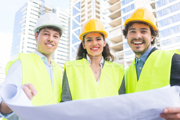 Stock photo: Architects with ground plot on construction site