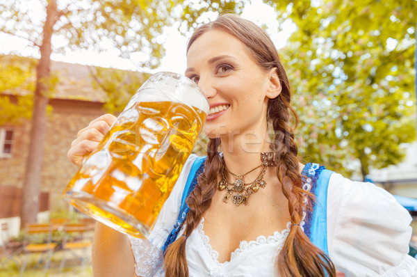Woman wearing Dirndl drinking beer  Stock photo © Kzenon