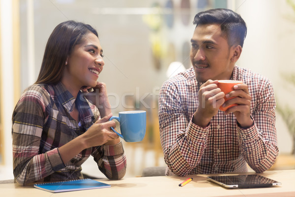 Young man and woman using a tablet while working together on a p Stock photo © Kzenon