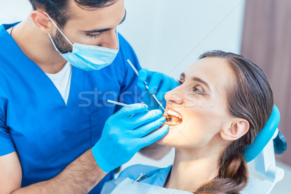 Beautiful woman looking with confidence at her reliable dentist  Stock photo © Kzenon