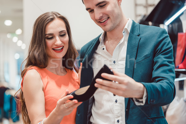 Man and woman thinking about buying pair of shoes Stock photo © Kzenon