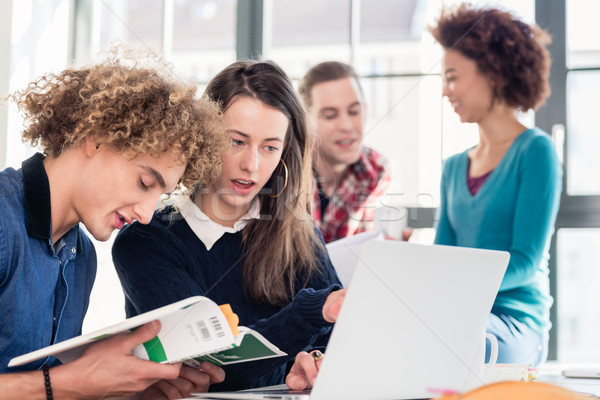 Two young students searching for an answer to their question Stock photo © Kzenon