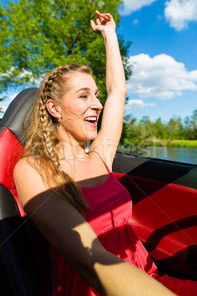 Young woman with cabriolet in summer on day trip Stock photo © Kzenon