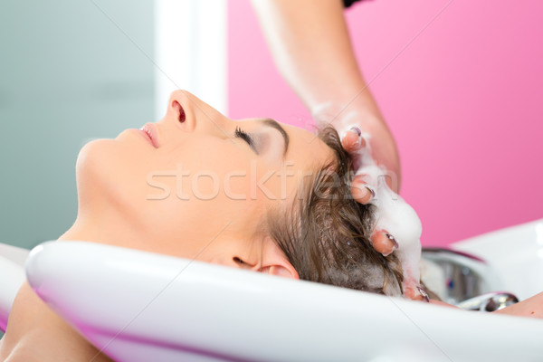 Woman at the hairdresser washing hair Stock photo © Kzenon
