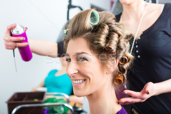 Hairdresser - hair stylist curling hairs Stock photo © Kzenon