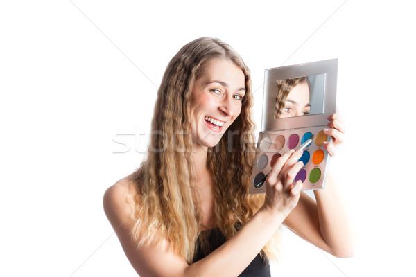 Woman putting make-up on Stock photo © Kzenon