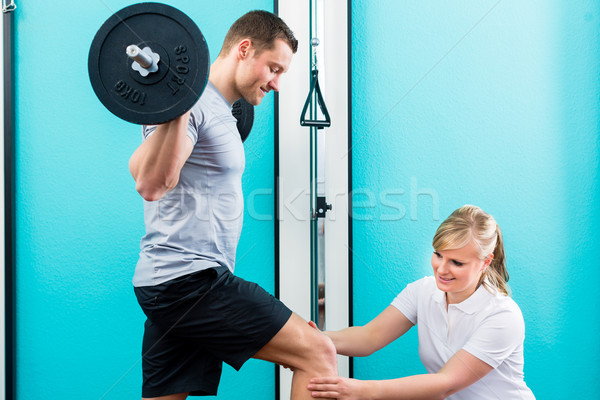 Physiotherapist or sport doctor with patient  Stock photo © Kzenon