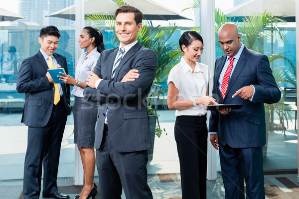 Business executive in front of his team Stock photo © Kzenon