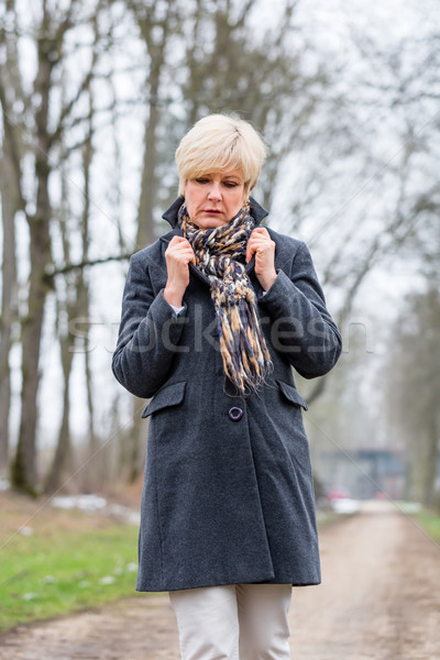 Depressed or sad woman walking in winter Stock photo © Kzenon