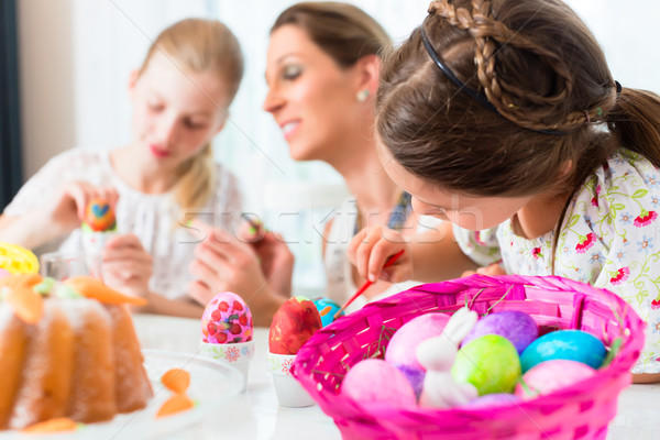Basket with Easter eggs having been colored by family Stock photo © Kzenon