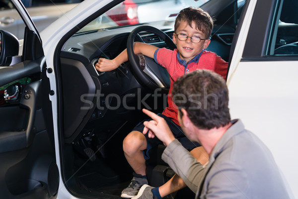 Father and son buying new family car at auto dealership Stock photo © Kzenon