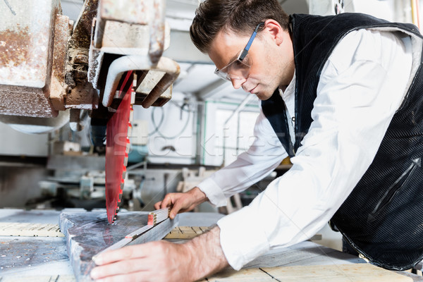 Craftsman measuring stone plate for sawing on diamond saw Stock photo © Kzenon