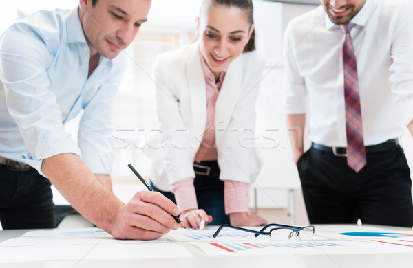 Business people analyzing data - glasses on graph Stock photo © Kzenon
